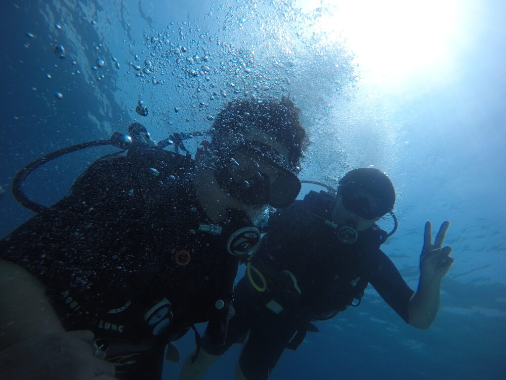 PADI instructor guiding beginner scuba student in Bali