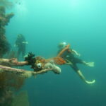 PADI Advanced Open Water 4 Rescue diver practicing recovery skills in Lovina Reef
